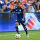 DeAndre Yedlin dribbles down field. Photo Courtesy Brian Mack